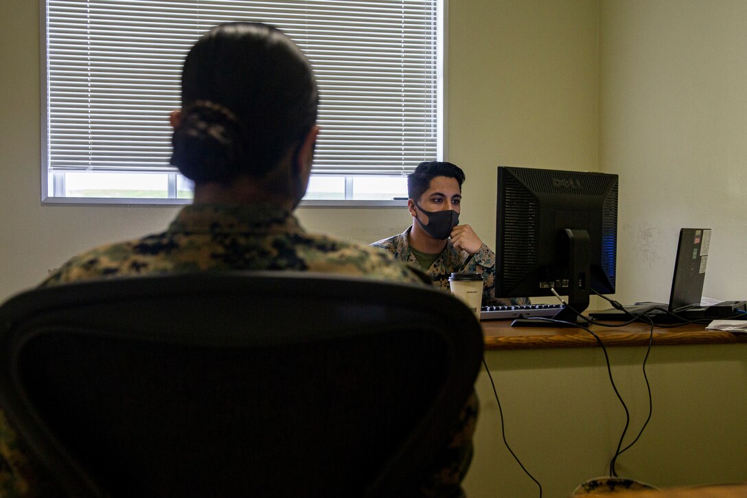 U.S. Marine Corps Lance Cpl. Jared Jones, right, a radio operator with 3d Landing Support Battalion, Combat Logistics Regiment 3, assists Cpl. Kelsy Marquez, a supply administration and operations specialist with 9th Engineer Support Battalion, 3D Marine Logistics Group, in her tax returns at the Camp Foster Tax Center on Camp Foster, Okinawa, Japan, Feb. 10, 2022. The Camp Foster Tax Center assists eligible taxpayers with the preparation of e-filing both federal income tax returns and state income tax returns, as applicable. The team at the Tax Center not only assists service members of any branch, but also any eligible taxpayer that has base access, including but not limited to retired service members aboard Okinawa, dependents, and status of forces agreement personnel. (U.S. Marine Corps photo by Lance Cpl. Alex Fairchild)