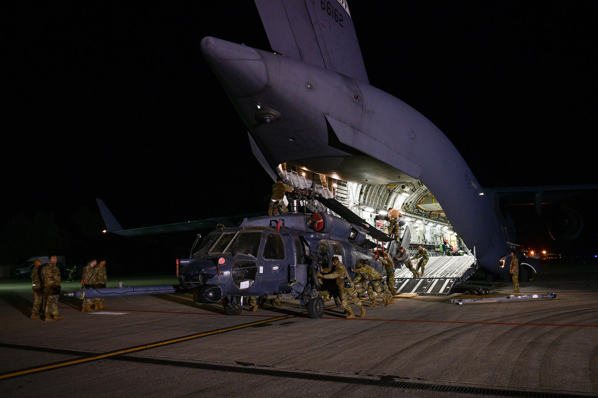 U.S. Air Force Airmen assigned to the 724th Air Mobility Squadron unload an HH-60G Pave Hawk that was deployed with the 56th Rescue Squadron, at Aviano Air Base, Italy, Feb. 9, 2022. The primary mission of the HH-60G is to conduct day or night personnel recovery operations into hostile environments to recover isolated personnel during war.  The 56th RQS integrates with the Guardian Angels weapon system and other special forces to support insertion, extraction and recovery of both U.S. and allied combatants. (U.S. Air Force photo by Senior Airman Brooke Moeder)