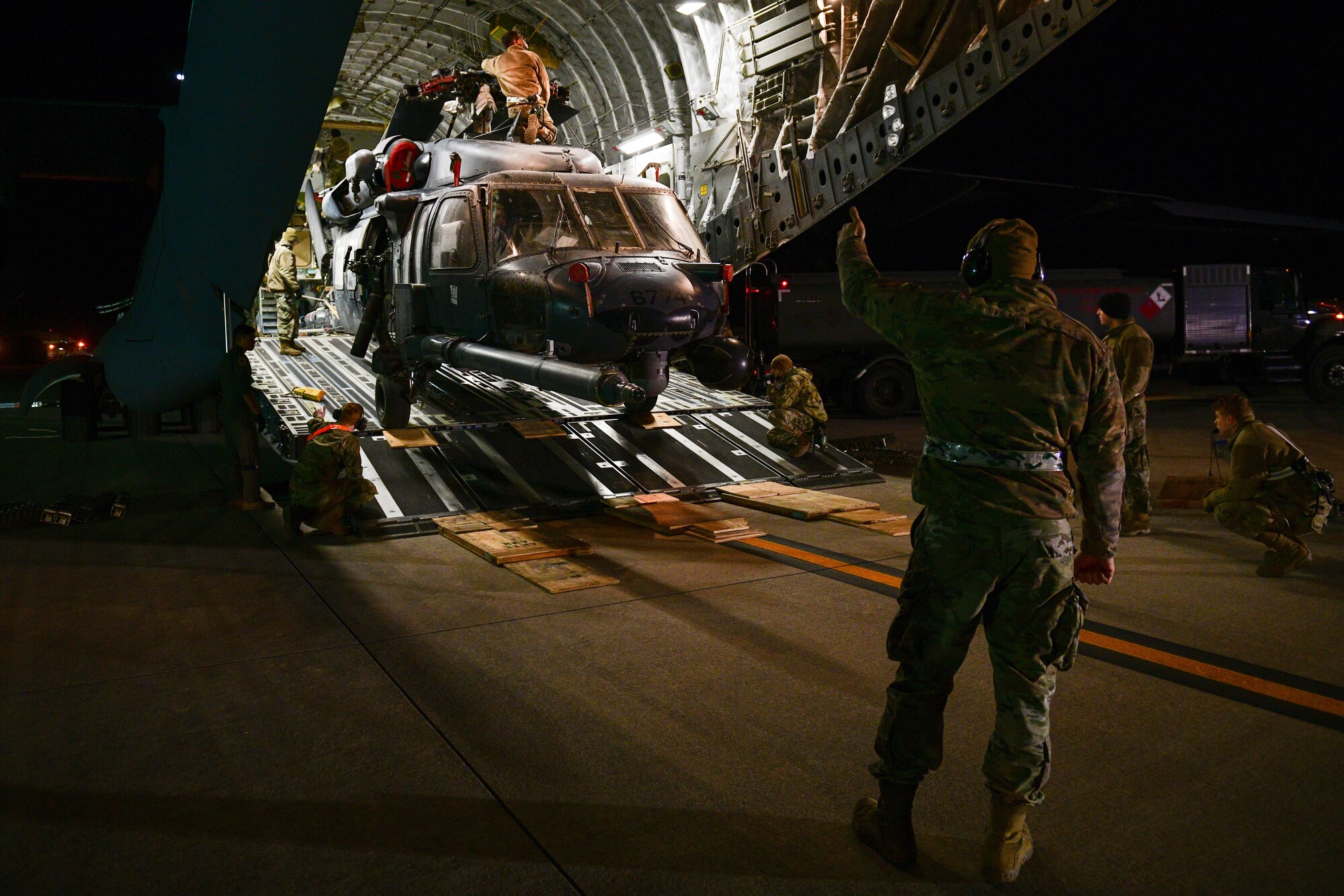 U.S. Air Force Airmen assigned to the 724th Air Mobility Squadron unload an HH-60G Pave Hawk assigned to the 56th Rescue Squadron at Aviano Air Base, Italy, Feb. 9, 2022. The HH-60G returned from a deployment with the 56th RQS and 56th Helicopter Maintenance Unit. The primary mission of the HH-60G Pave Hawk helicopter is to conduct day or night personnel recovery operations into hostile environments to recover isolated personnel during war. (U.S. Air Force photo by Senior Airman Brooke Moeder)