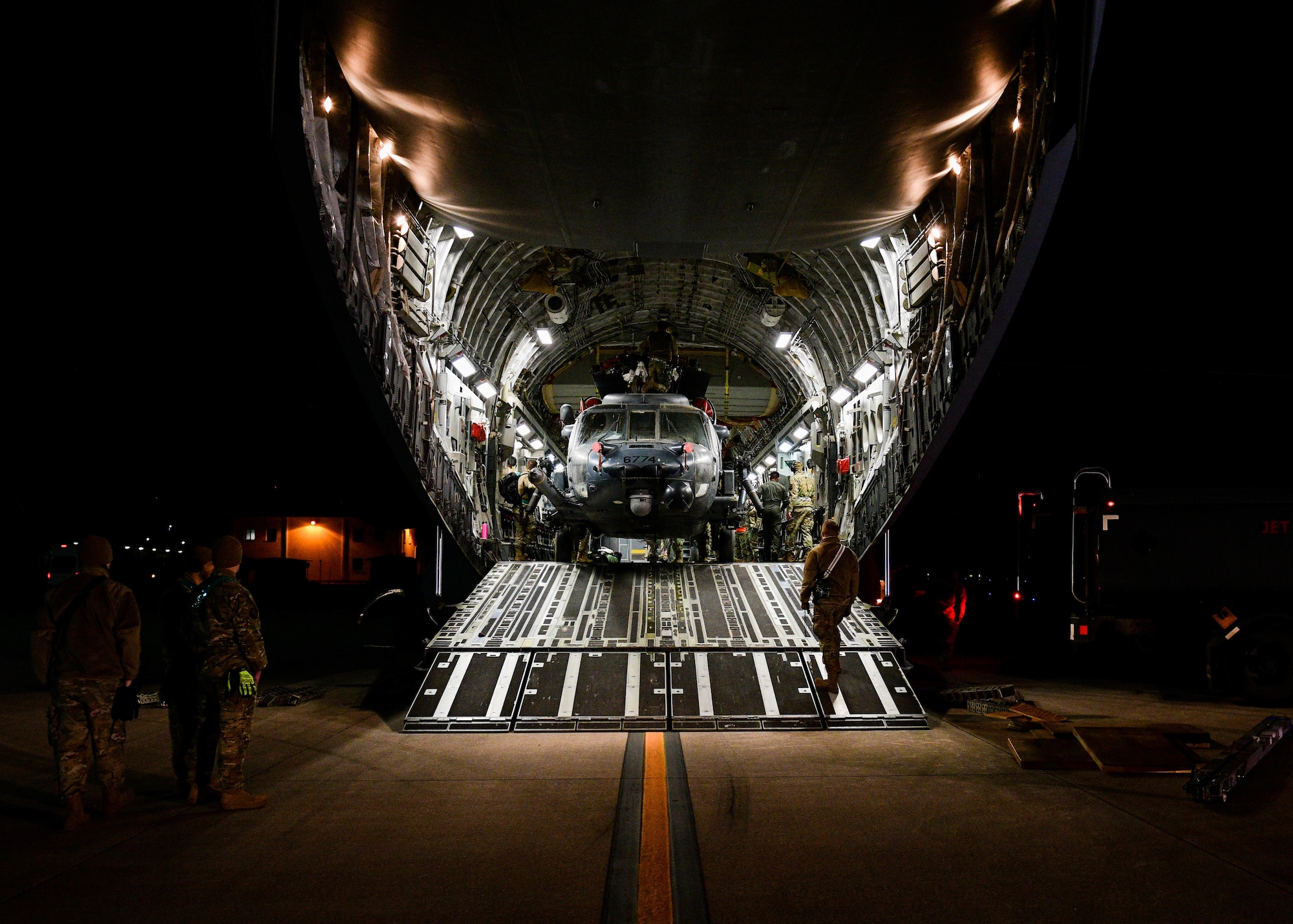 An HH-60G assigned to the 56th Rescue Squadron returns from a deployment in a C-17 Globemaster at Aviano Air Base, Italy, Feb. 9, 2022. The HH-60G is tasked to perform military operations other than war, including civil search and rescue, medical evacuation, disaster response, humanitarian assistance, security cooperation/aviation advisory, NASA space flight support, and rescue command and control. (U.S. Air Force photo by Senior Airman Brooke Moeder)