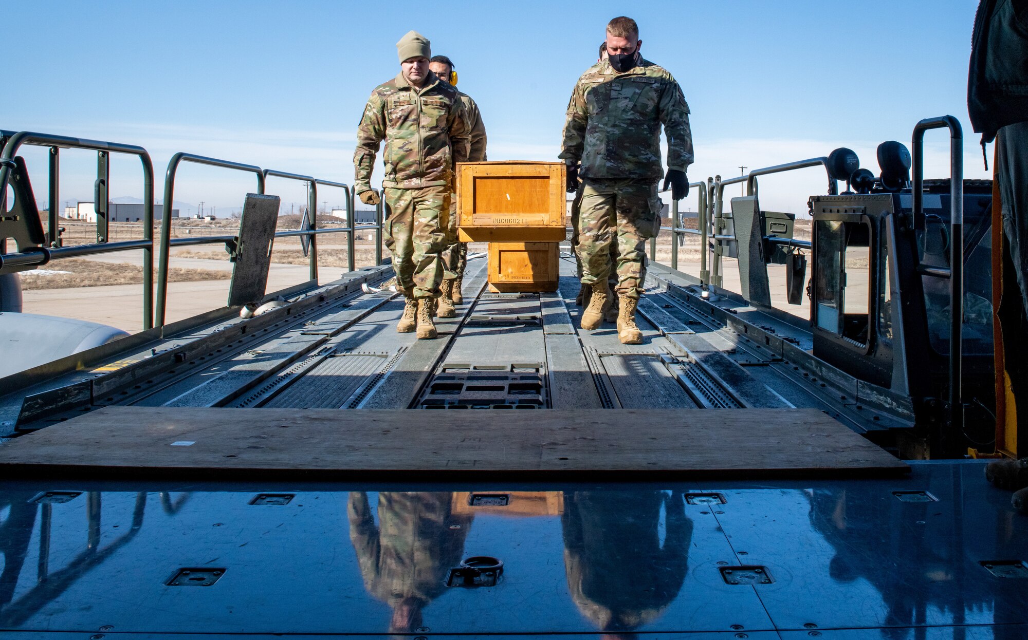 Air Force reservists from the 67th Aerial Port Squadron carry an empty casket box onto a KC-135 as part of a cargo loading exercise Feb. 5, 2022 at Hill Air Force Base, Utah