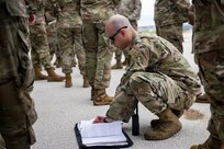 U.S. Air Force Tech. Sgt. Alex Covert, 96th Expeditionary Bomb Squadron flight line expediter, looks over forms following the landing of B-52 Stratofortress aircraft for a Bomber Task Force deployment at Andersen Air Force Base, Guam, Feb. 11, 2022. The U.S. routinely and visibly demonstrates commitment to our allies and partners through the global employment of our military forces in Bomber Task Force missions. (U.S. Air Force photo by Staff Sgt. Lawrence Sena)