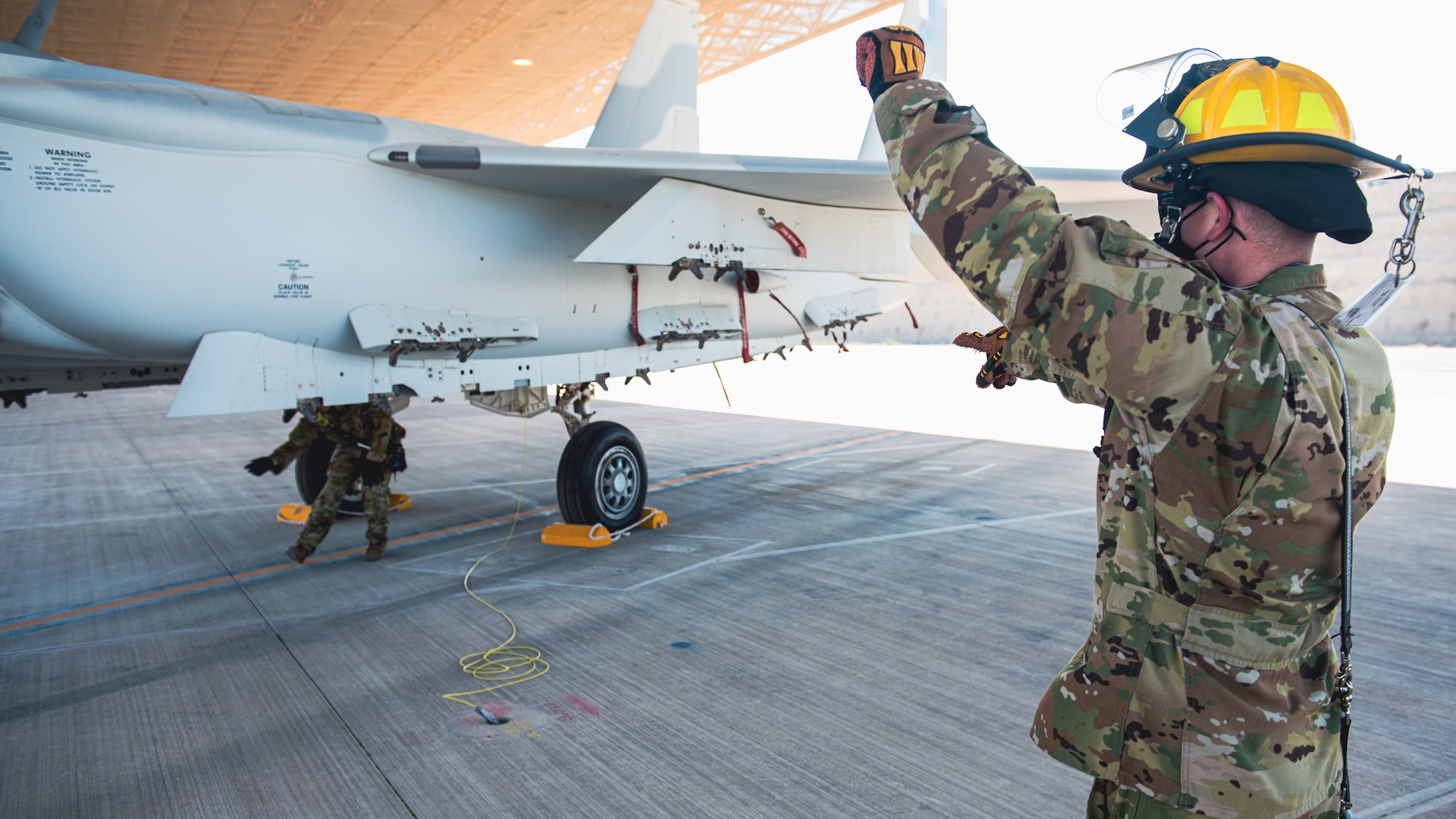 Airman uses hand signals.