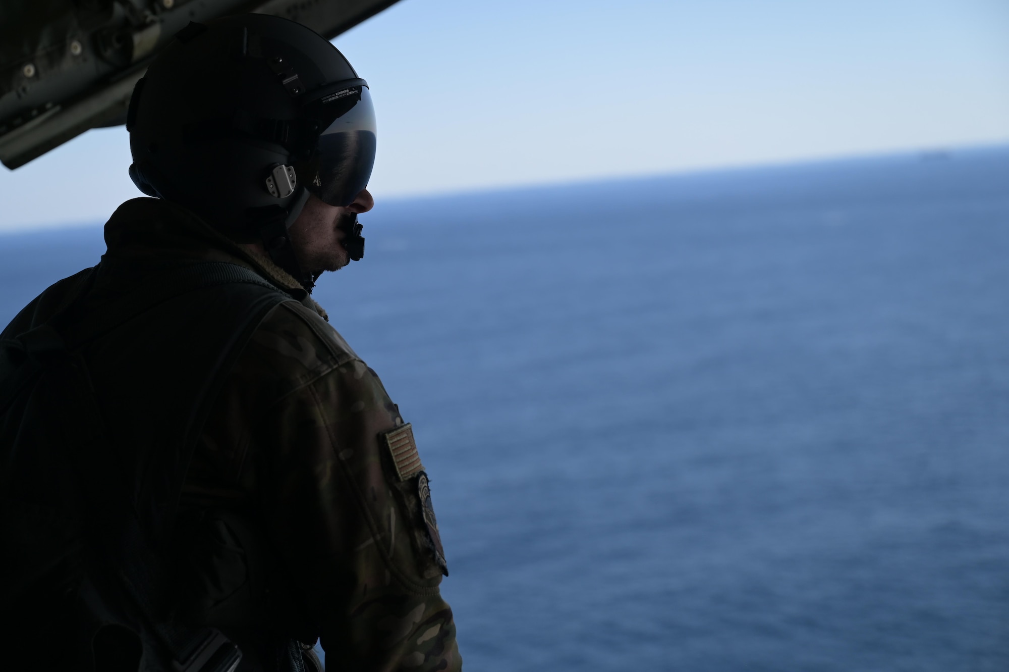 Staff. Sgt. Wesley Zech, an instructor loadmasters assigned to the 36th Airlift Squadron, scans the water aboard a C-130J Super Hercules near the Irozaki Cape, Japan, during exercise Tomodachi Rescue 22 Feb. 11, 2022.