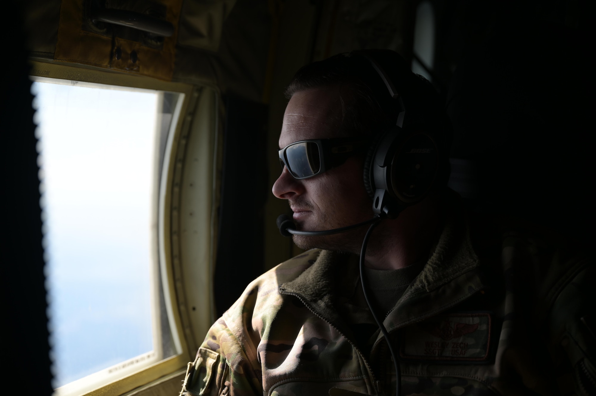 Staff. Sgt. Wesley Zech, an instructor loadmaster assigned to the 36th Airlift Squadron, scans the horizon aboard a C-130J Super Hercules near Yokota Air Base, Japan, during exercise Tomodachi Rescue 22 Feb. 11, 2022.