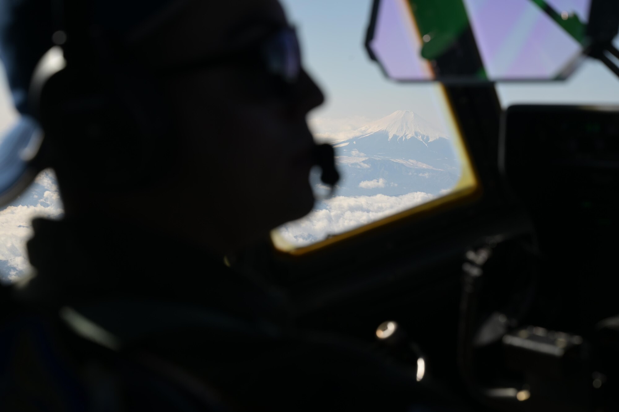 A pilot, assigned to the 36th Airlift Squadron, steers a C-130J Super Hercules passed Mt. Fuji, Japan, during exercise Tomodachi Rescue 22 Feb. 11, 2022.