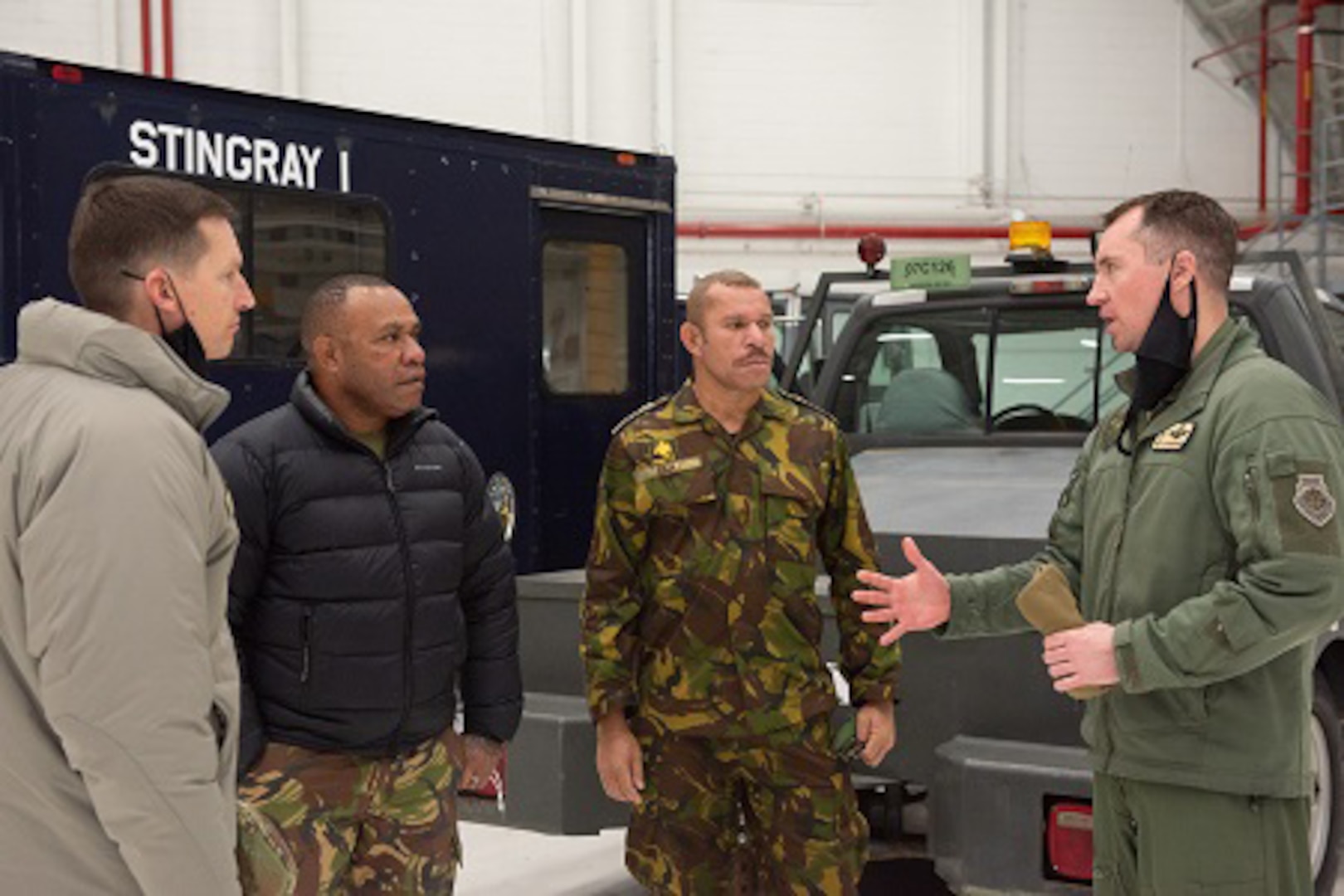 Military leaders from Papua New Guinea speak with Wisconsin National Guard leaders from the 115th Fighter Wing Feb. 5, 2022, in Madison, Wis., during a historic first visit to Wisconsin through the State Partnership Program. The program links individual states with armed forces of partner nations  to forge lasting cooperation, friendship and mutually beneficial relationships.