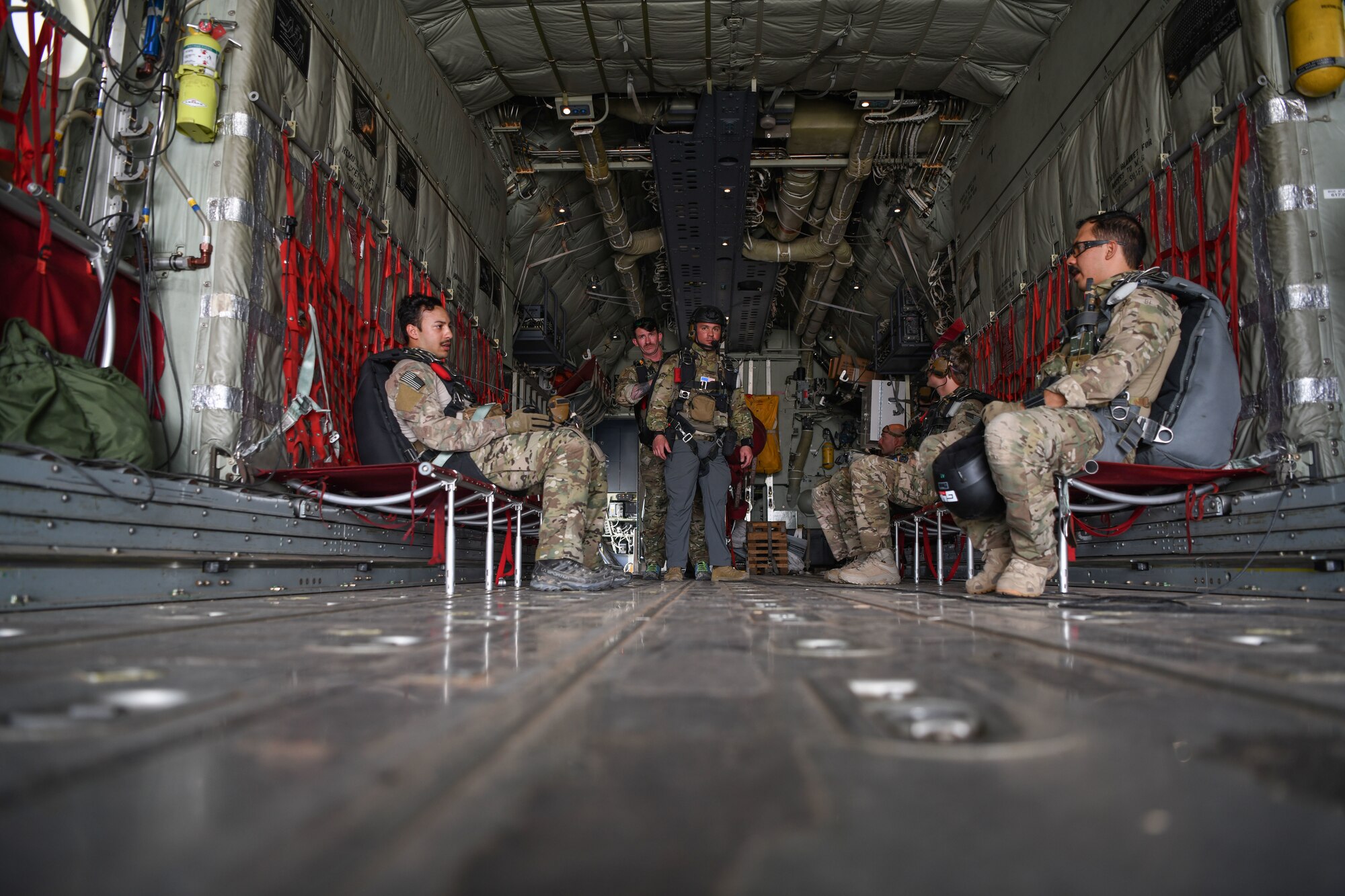 U.S. Air Force pararescuemen assigned to the 82nd Expeditionary Rescue Squadron, wait to reach altitude aboard a U.S. Marine Corps KC-130J Super Hercules before conducting jump training at Camp Lemonnier, Djibouti, Feb. 15, 2021.  The 82nd ERQS maintains jump proficiency to provide secure, reliable, flexible combat search, rescue, and recovery capabilities in support of U.S. Africa Command in North and East Africa. The 82nd ERQS serves as U.S. Air Forces Africa’s personnel recovery liaison, coordinating efforts between coalition and joint forces in East Africa and enhancing the combatant command’s Warfighter Recovery Network. (U.S. Air Force photo by Senior Airman Ericka A. Woolever)