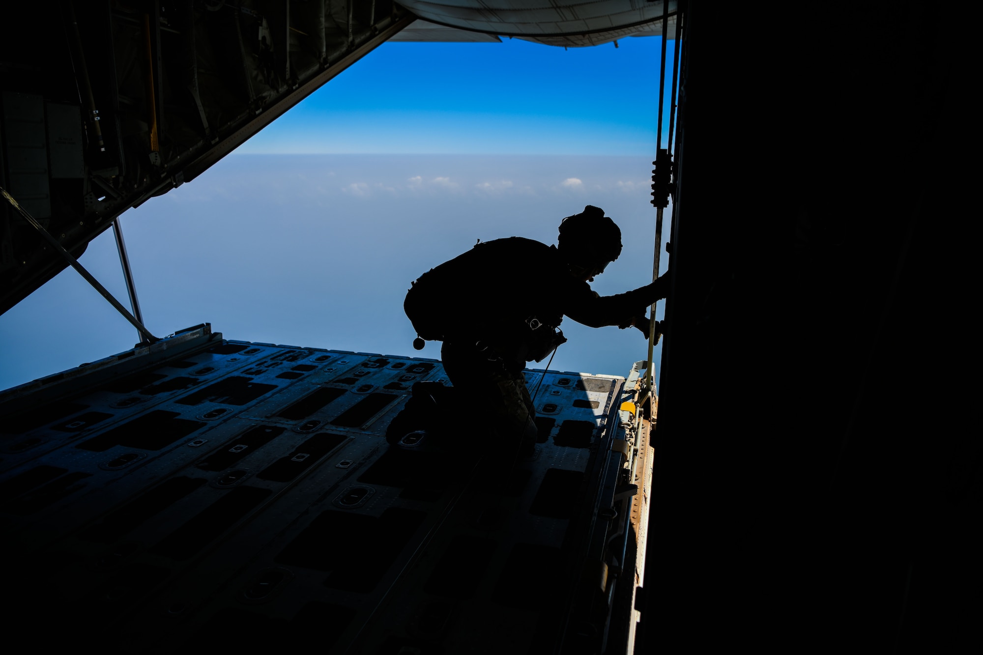 U.S. Air Force pararescuemen assigned to the 82nd Expeditionary Rescue Squadron, prepare for a training jump from a U.S. Marine Corps KC-130J Super Hercules over East Africa, Feb. 15, 2021. The 82nd ERQS maintains jump proficiency to provide secure, reliable, flexible combat search, rescue, and recovery capabilities in support of U.S. Africa Command in North and East Africa. They are qualified experts in advanced weapons and small unit tactics, airborne and military free fall, combat divers, high angle and confined space rescue operations, small boat and vehicle craft utilization, rescue swimmers, and battlefield trauma-paramedics. (U.S. Air Force photo by Senior Airman Ericka A. Woolever)