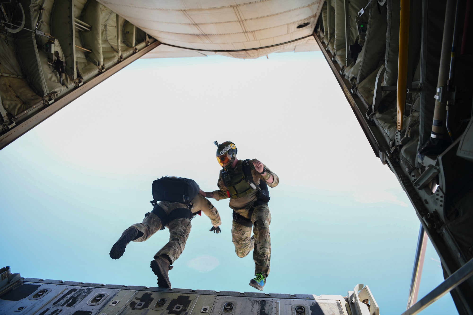 Two U.S. Air Force pararescuemen assigned to the 82nd Expeditionary Rescue Squadron, jump from a U.S. Marine Corps KC-130J Super Hercules over East Africa, Feb. 15, 2021. The 82nd ERQS maintains jump proficiency to provide secure, reliable, flexible combat search, rescue, and recovery capabilities in support of U.S. Africa Command in North and East Africa. (U.S. Air Force photo by Senior Airman Ericka A. Woolever)