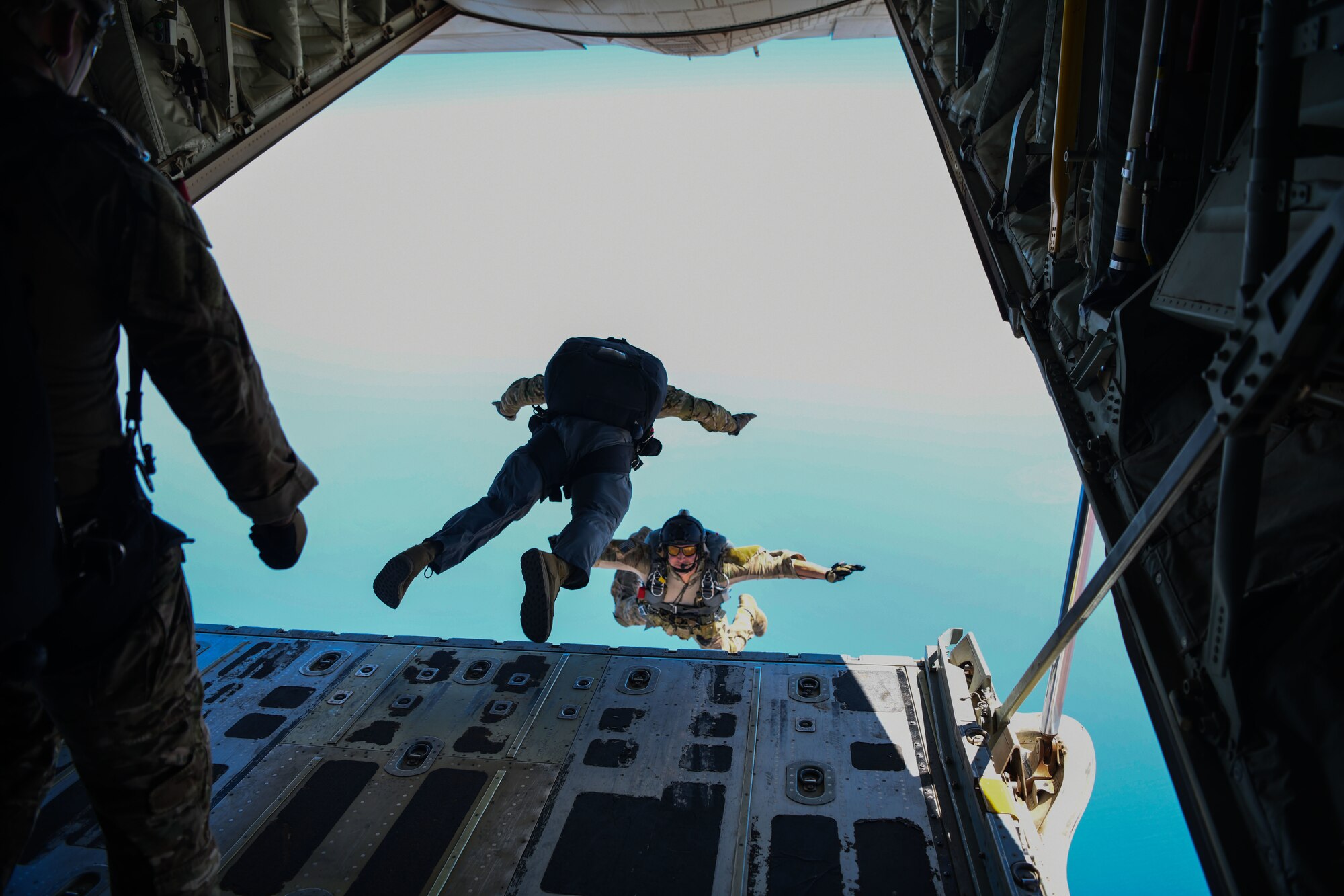 Two U.S. Air Force pararescuemen assigned to the 82nd Expeditionary Rescue Squadron, jump from a U.S. Marine Corps KC-130J Super Hercules over East Africa, Feb. 15, 2021. The 82nd ERQS maintains jump proficiency to provide secure, reliable, flexible combat search, rescue, and recovery capabilities in support of U.S. Africa Command in North and East Africa. The 82nd ERQS are qualified experts in advanced weapons and small unit tactics, airborne and military free fall, combat divers, high angle and confined space rescue operations, small boat and vehicle craft utilization, rescue swimmers, and battlefield trauma-paramedics. (U.S. Air Force photo by Senior Airman Ericka A. Woolever)