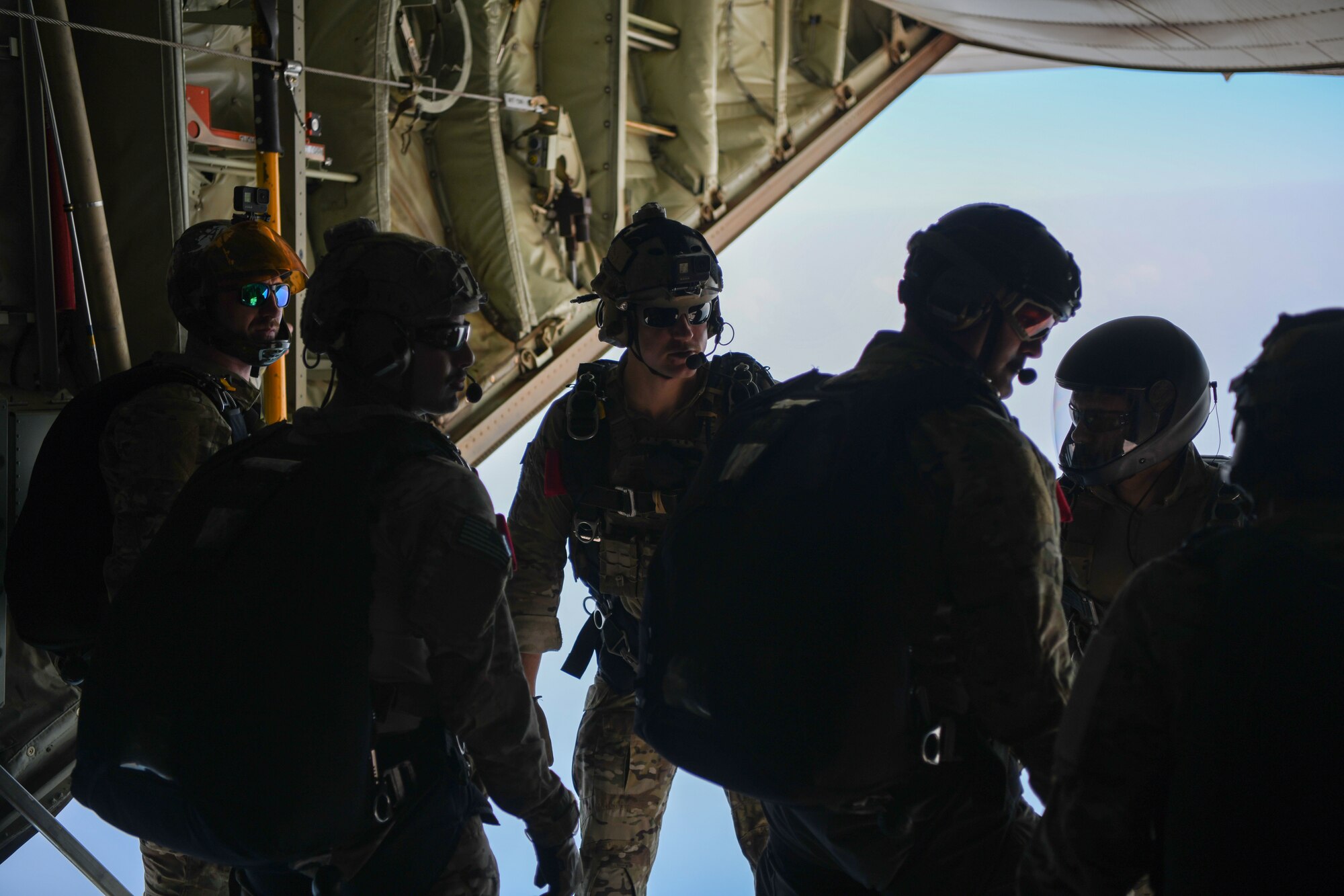 U.S. Air Force pararescuemen assigned to the 82nd Expeditionary Rescue Squadron, prepare for a training jump from a U.S. Marine Corps KC-130J Super Hercules over East Africa, Feb. 15, 2021. The 82nd ERQS maintains jump proficiency to provide secure, reliable, flexible combat search, rescue, and recovery capabilities in support of U.S. Africa Command in North and East Africa. They are qualified experts in advanced weapons and small unit tactics, airborne and military free fall, combat divers, high angle and confined space rescue operations, small boat and vehicle craft utilization, rescue swimmers, and battlefield trauma-paramedics. (U.S. Air Force photo by Senior Airman Ericka A. Woolever)