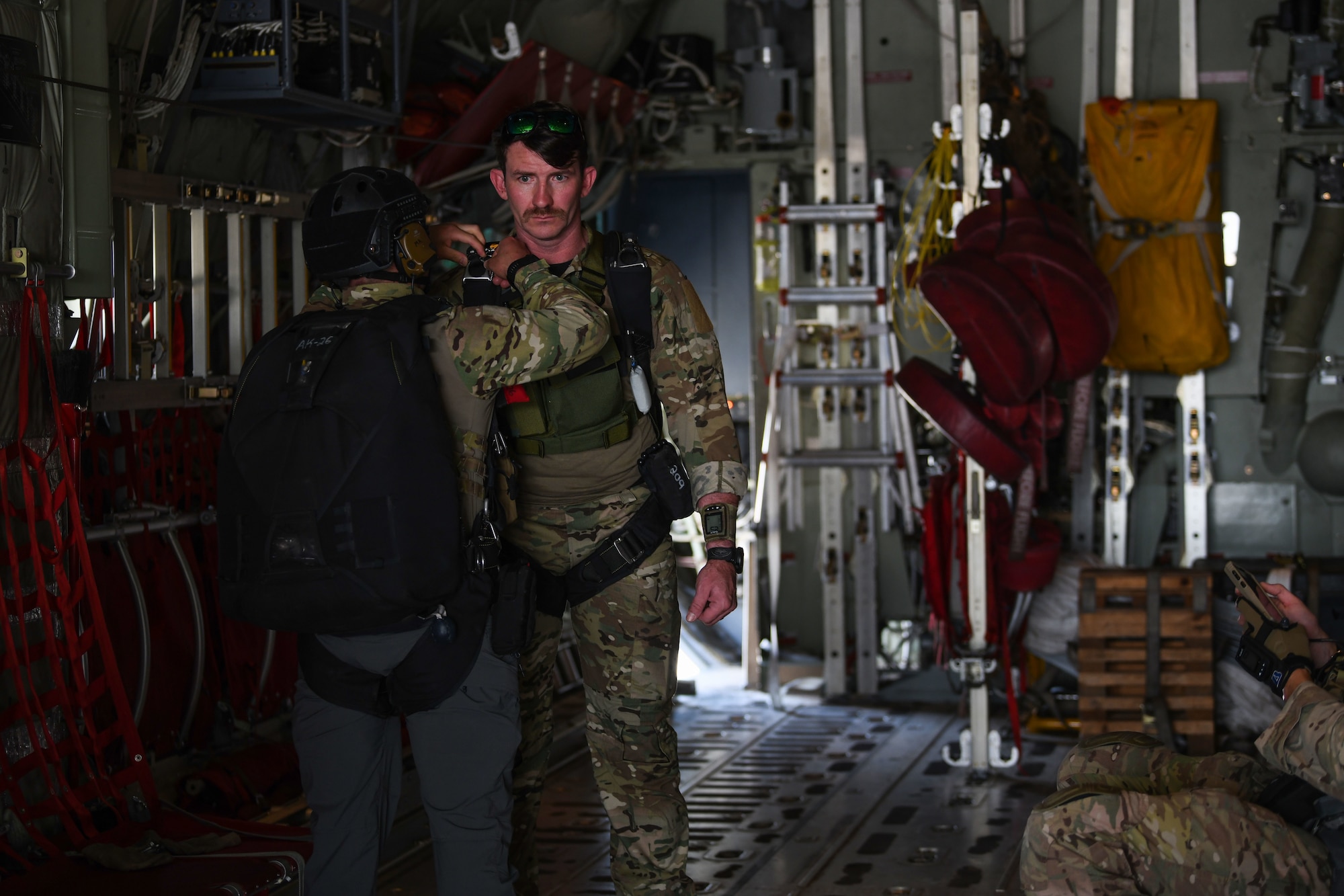 Two U.S. Air Force pararescuemen assigned to the 82nd Expeditionary Rescue Squadron, check one another's parachutes aboard a U.S. Marine Corps KC-130J Super Hercules at Camp Lemonnier, Djibouti, Feb. 15, 2021. The 82nd ERQS maintains jump proficiency to provide secure, reliable, flexible combat search, rescue, and recovery capabilities in support of U.S. Africa Command in North and East Africa. They also serve as U.S. Air Forces Africa’s personnel recovery liaison, coordinating efforts between coalition and joint forces in East Africa and enhancing the combatant command’s Warfighter Recovery Network. (U.S. Air Force photo by Senior Airman Ericka A. Woolever)