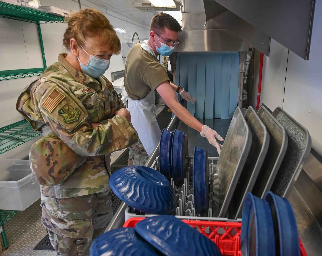 U.S. Air Force Brig. Gen. Donna Prigmore, Oregon Air National Guard commander, visits Senior Airman Nathan Turpen, a 173rd FW hydraulics mechanic, while he washes dishes at Providence Medford Medical Center Feb. 4, 2022. Nearly 1,200 Oregon Guardsmen are activated around the state of Oregon to help hospitals cope with heavy patient loads and low staffing during the COVID-19 pandemic.