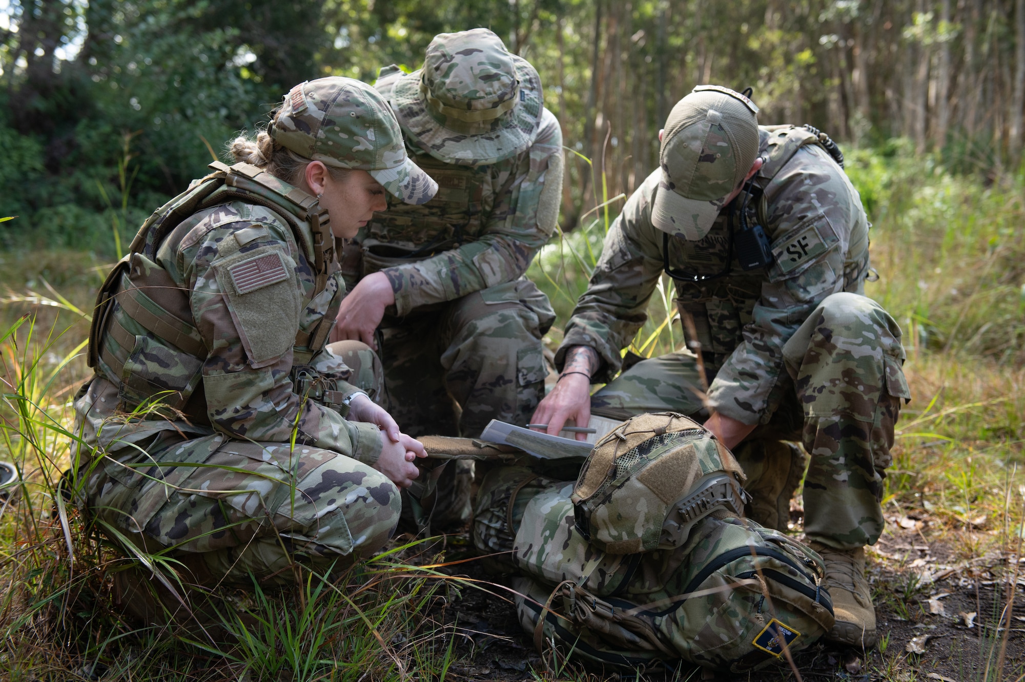 Security Forces Airmen assigned to the 115th Security Forces Squadron, Truax Field, Madison, Wisconsin navigate through Hawaii's tropical terrain during a survival and training exercise Jan. 14, 2022. Throughout the two-week training, the group of Wisconsin Air National Guardsmen participated in land navigation, water survival and combative training. (U.S. Air National Guard photo by Tech. Sgt. Andrea Rhode)