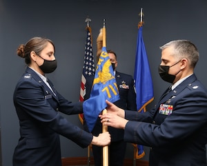 Col. Jennifer Mulder, 655th Intelligence, Surveillance and Reconnaissance Group commander, passes the guidon to incoming 71st Intelligence Squadron commander, Lt. Col. David Amar, during a change of command ceremony Feb. 12, 2022. Lt. Col. Heidi Nelson relinquished command of the squadron to Amar.