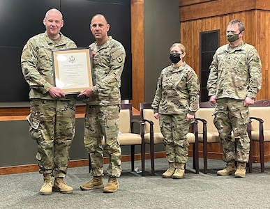 Staff Sgt. Phillip Sawyer, of Anna, Illinois, an instructor with 2nd Battalion, 129th Regiment (Regional Training Institute) accepts the Certificate of Retirement from Col. Daniel Reichen, of Springfield, Illinois, Commander, 129th RTI, during Sawyer’s retirement ceremony Feb. 12