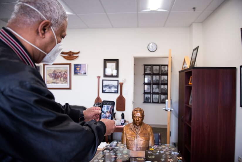 man takes photo of statue