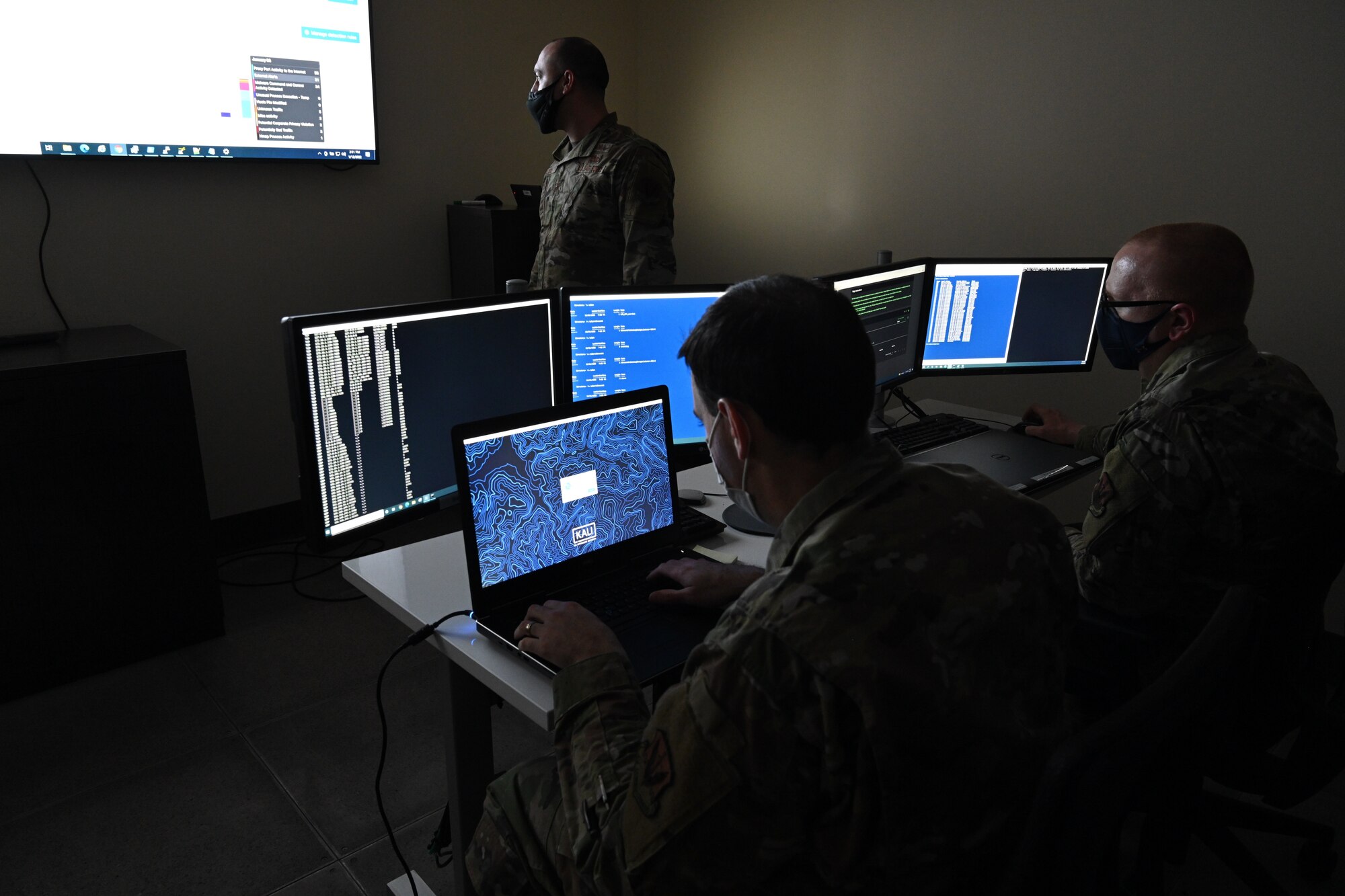 U.S Air Force Capt. John Tibbetts, Network Analyst Lead for the 275th Cyber Operations Group, U.S Air Force Tech. Sgt. Justin Rodgers, Host Analyst Lead for the 275th COS, and U.S Air Force Master Sgt. Zachary Lidie, Network Analyst for the 275th COS, go over a defensive training conducted in November, in the Cyber operations building at the 175 Wing, Warfield Air National Guard Base, Middle River, Md, Jan. 12, 2022.  The mission entailed airmen in a T-32 status conducting unscripted training on the base NIPR network. (U.S. Air National Guard photo by A1C Alexandra Huettner)
