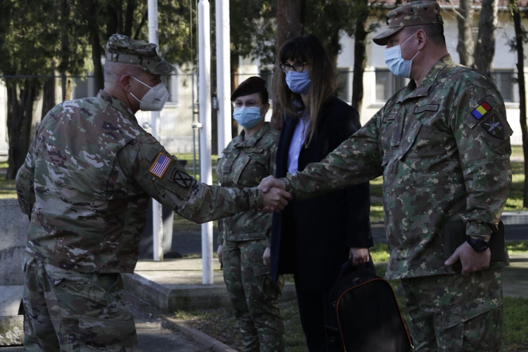 U.S. Army Gen. Christopher G. Cavoli, U.S. Army Europe and Africa commander, greets Romanian service members during a visit to Mihail Kogălniceanu Air Base, Romania, February 16, 2022. A forward presence in Europe with U.S. and Romanian troops working side by side, builds interoperability, trust, and strengthens our shared commitment to NATO. (U.S. Army photo by Adam M. Manternach)