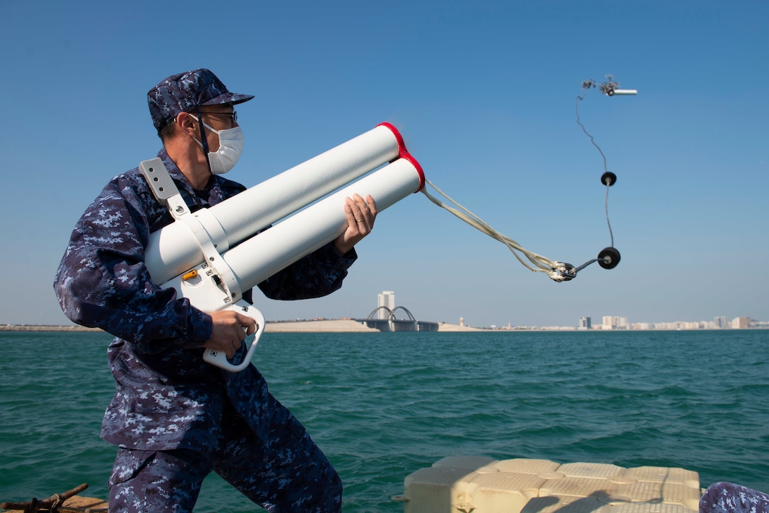 MANAMA, Bahrain (Feb. 13, 2022) Lt. Yoshihiro Kimura of the Japanese Maritime Self-Defense Force fires an arresting gear launcher, designed to slow or halt a small vessel, in a training evolution during International Maritime Exercise/Cutlass Express 2022, Feb 13. IMX/Cutlass Express 2022 is the largest multinational training event in the Middle East, involving more than 60 nations and international organizations committed to enhancing partnerships and interoperability to strengthen maritime security and stability. (U.S. Navy photo by Mass Communication Specialist 2nd Class Helen Brown)