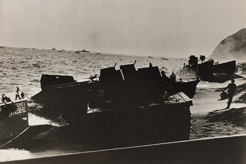 A landing craft sits on a beach.