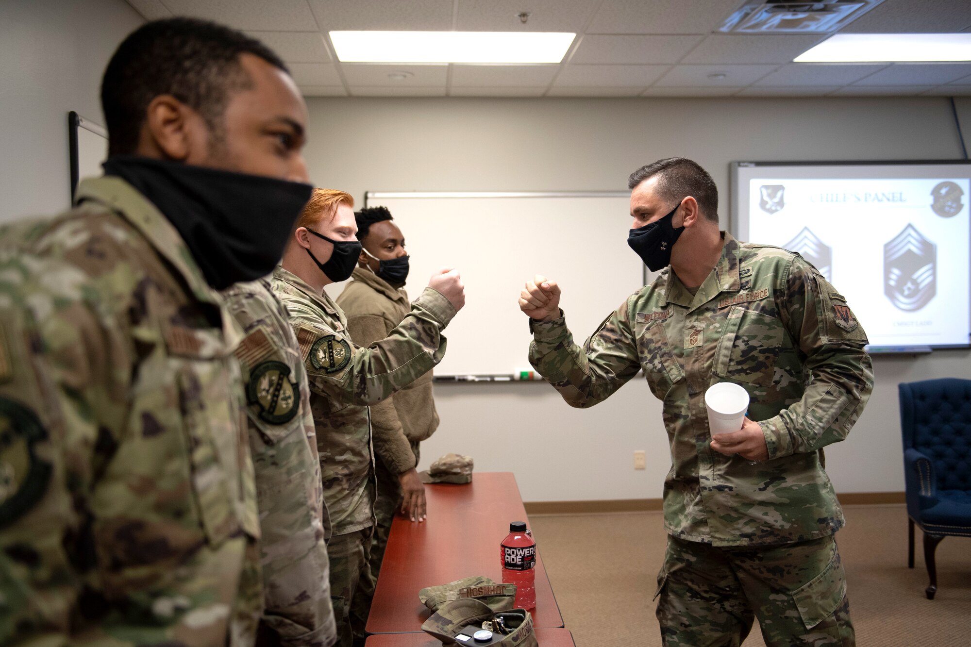 U.S. Air Force Chief Master Sgt. James Wilfong, 23rd Wing Command Chief, fist bumps Airmen after a Chief's Panel during a Flying Tigers University course at Moody Air Force Base, Georgia, January 28, 2022. The Flying Tigers University is an in-house mentorship program that provides Airmen with the skills to communicate at all levels. (U.S. Air Force photo by Airman 1st Class Rachel Perkinson.)