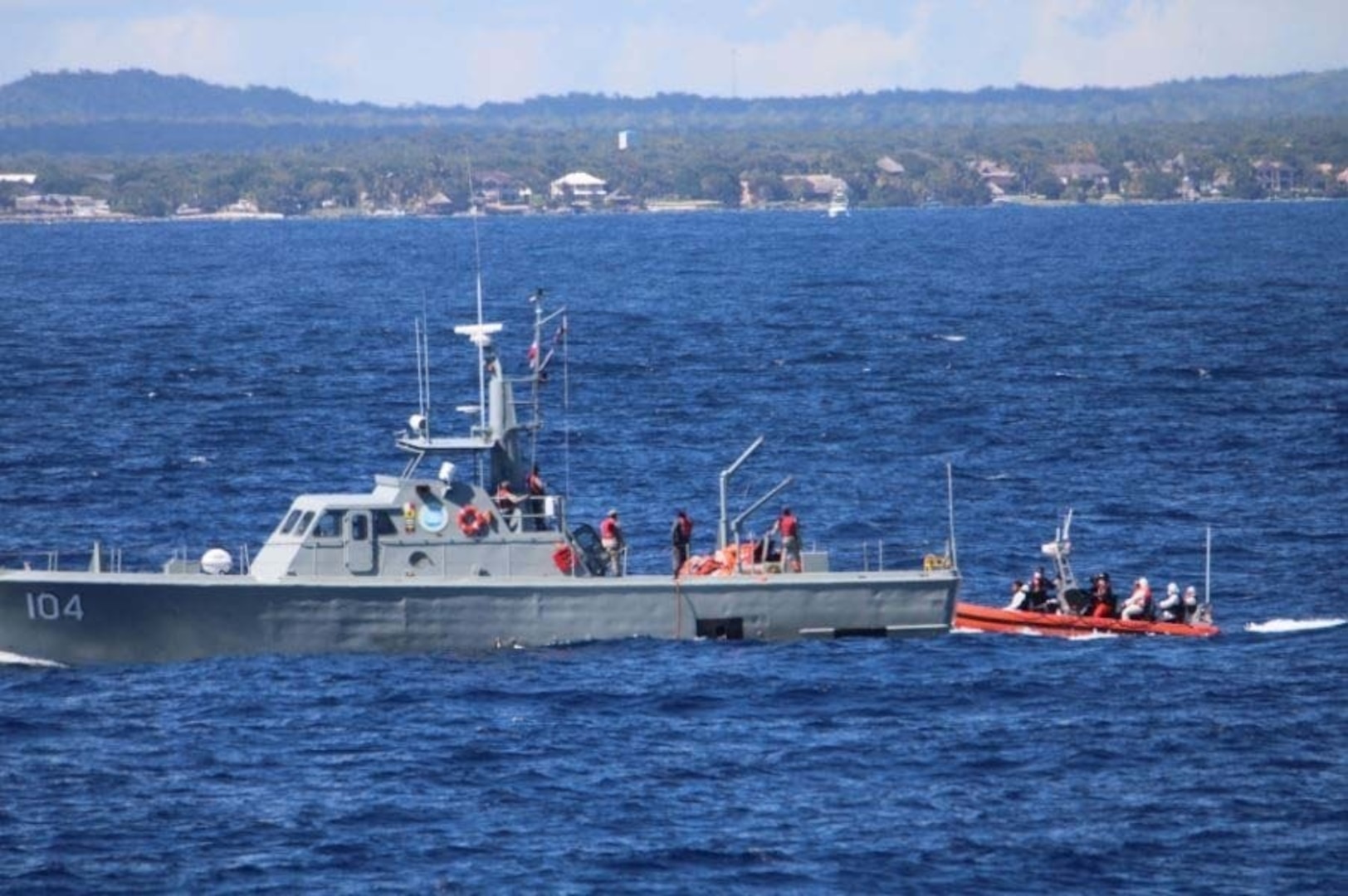 The Coast Guard Cutter Valiant (WMEC 621) crew approaches a Dominican Republic Navy vessel Aldebaran (GC-104) crew in the Caribbean Sea during a 30-day patrol Feb. 11, 2022. The Valiant crew transferred migrants to the Aldebaran crew for repatriation. (U.S. Coast Guard courtesy photo)