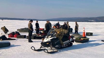 Airmen assigned to the New York Air National Guard's 109th Airlift Wing prepare to set up camp on the ice of the Great Sacandaga Lake near Northville, New York, Feb. 15, 2022. The Airmen were training on the tasks involved with creating an ice "ski-way" to land massive ski-equipped LC-130 Hercules aircraft on ice in the polar regions.