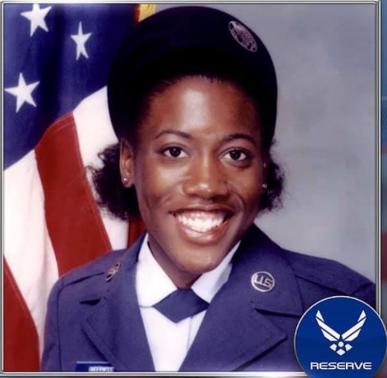 A woman in an Air Force uniform smiles for a photo.