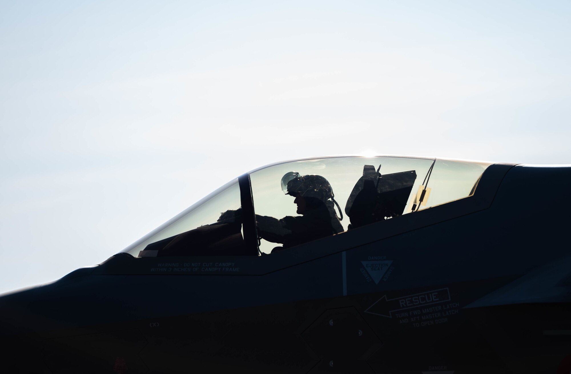 A pilot sits in a cockpit