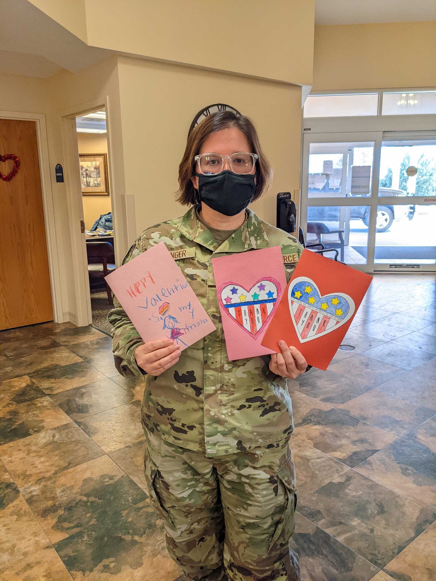U.S. Air Force Senior Airman Gloria Conger, 97th Air Mobility Wing command post, poses with Valentine’s Day cards at Magnolia Creek Skilled Nursing and Therapy, Oklahoma, Feb. 14, 2022. Several Airmen from multiple squadrons were a part of the Valentines for Vets volunteer event. (U.S. Air Force photo by Sydney Doorn)