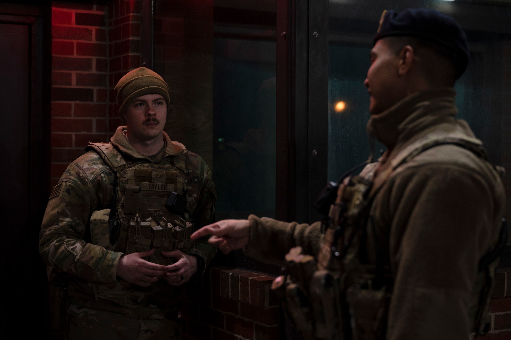 U.S. Air Force Airman 1st Class Keith Lautez, 375th Security Forces Squadron entry controller, talks about the Phoenix Raven program with Senior Airman Chase Taylor, 375th Security Forces Squadron patrolman at Scott Air Force Base, Illinois, Feb. 10, 2022. Lautez has worked with eight Airmen from the 375th Security Forces Squadron to prepare them for Phoenix Raven training. (U.S. Air Force photo by Staff Sgt. Dalton Williams)