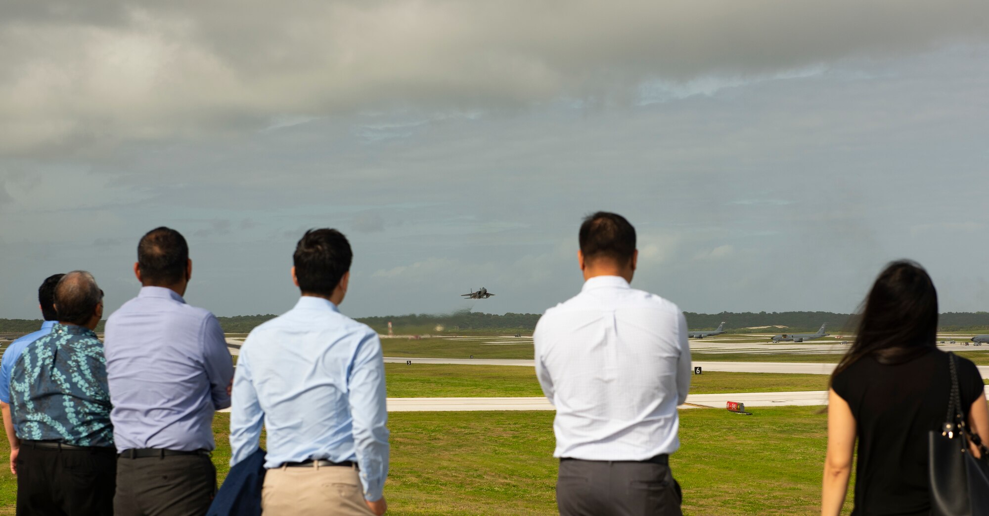 Spectators from the local community watch aircraft take off from Andersen Air Force Base, Guam, during a take-off viewing day for exercise Cope North 22, Feb. 15, 2022. Service members, their families, and local hotel managers and workers were invited to the flight line to learn the importance of Cope North while observing aircraft capabilities.  Exercise Cope North is the U.S. Pacific Air Forces’ largest multilateral exercise and includes more than 2,500 U.S. Airmen, Marines, and Sailors working alongside 1,000 combined Japan Air Self-Defense Force and Royal Australian Air Force counterparts. (U.S. Air Force Photo by Senior Airman Helena Owens)