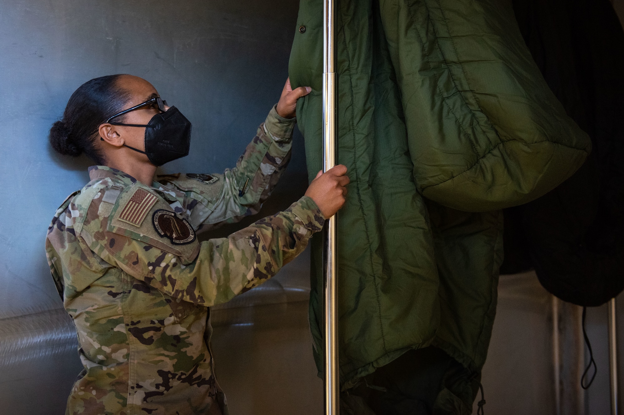 U.S. Air Force Master Sgt. Adriane M. Pope, 87th Logistics Readiness Squadron individual protective equipment section chief, removes sanitized sleeping bags from an ISU-90 shipping container at Joint Base McGuire-Dix-Lakehurst, N.J., Feb. 10, 2022. The gear was completely sanitized within 30 minutes, which is beneficial when looking into sustainment of the future fight. (U.S. Air Force photo by Airman 1st Class Sergio Avalos)