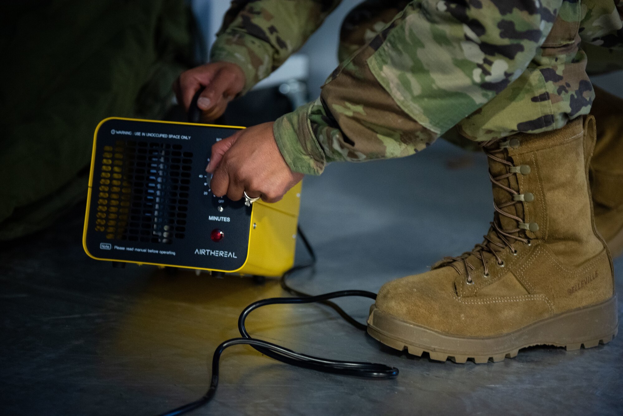 U.S. Air Force Master Sgt. Adriane M. Pope, 87th Logistics Readiness Squadron individual protective equipment section chief, turns on a 10-lb ozone generator inside an ISU-90 shipping container at Joint Base McGuire-Dix-Lakehurst, N.J., Feb. 10, 2022. This sanitation method is being tested in order to develop a less cumbersome solution for cleaning deployment gear. (U.S. Air Force photo by Airman 1st Class Sergio Avalos)