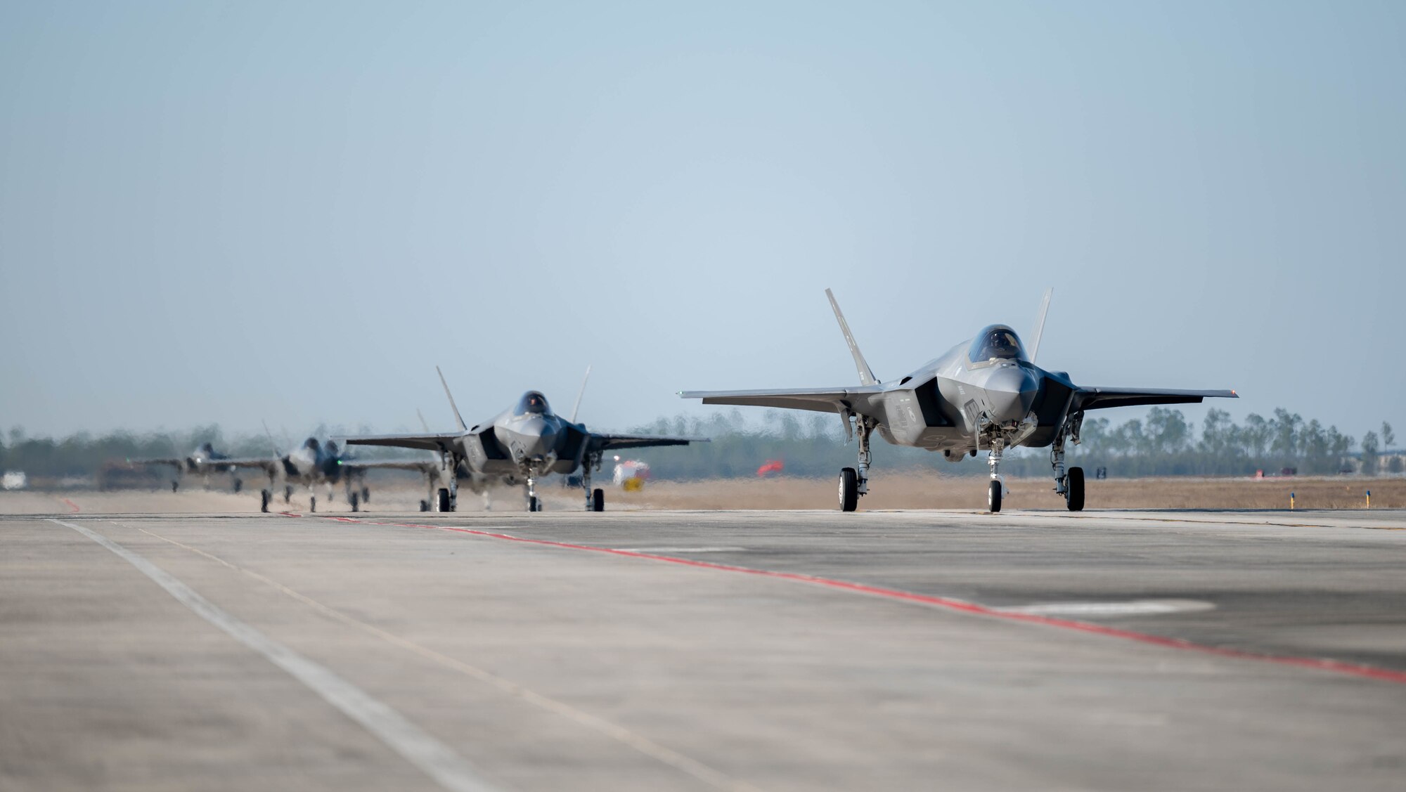 F-35A Lightning IIs taxi on the flight line.