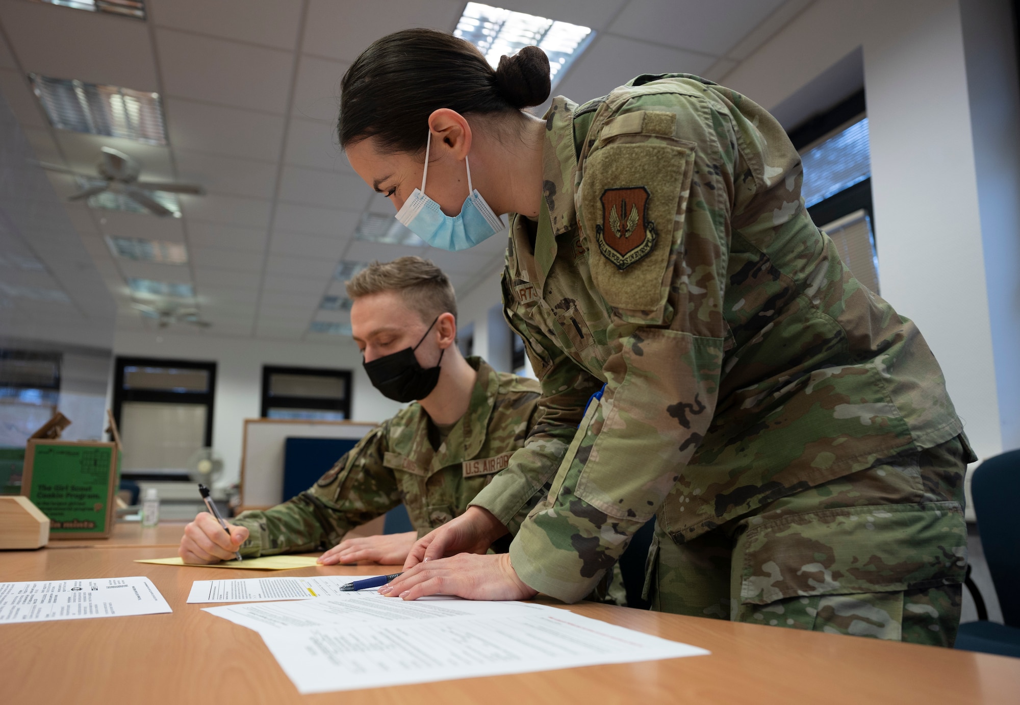 U.S. Air Force 1st Lt. Ashley Hartshorn, officer in charge of the Ramstein Tax Center, assists a client prepare their taxes at Ramstein Air Base, Germany, Feb. 16, 2022. Hartshorn and six other volunteers are standing by to help members of the Kaiserslautern Military Community with their taxes and 2022 returns. (U.S. Air Force photo by Senior Airman Thomas Karol)