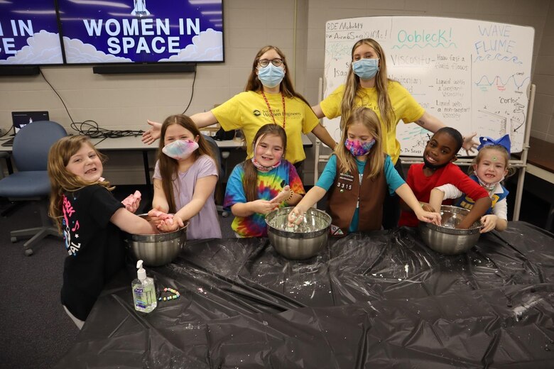 Taylor Cagle (left) and Samantha Weist lead the oobleck slime experiment.