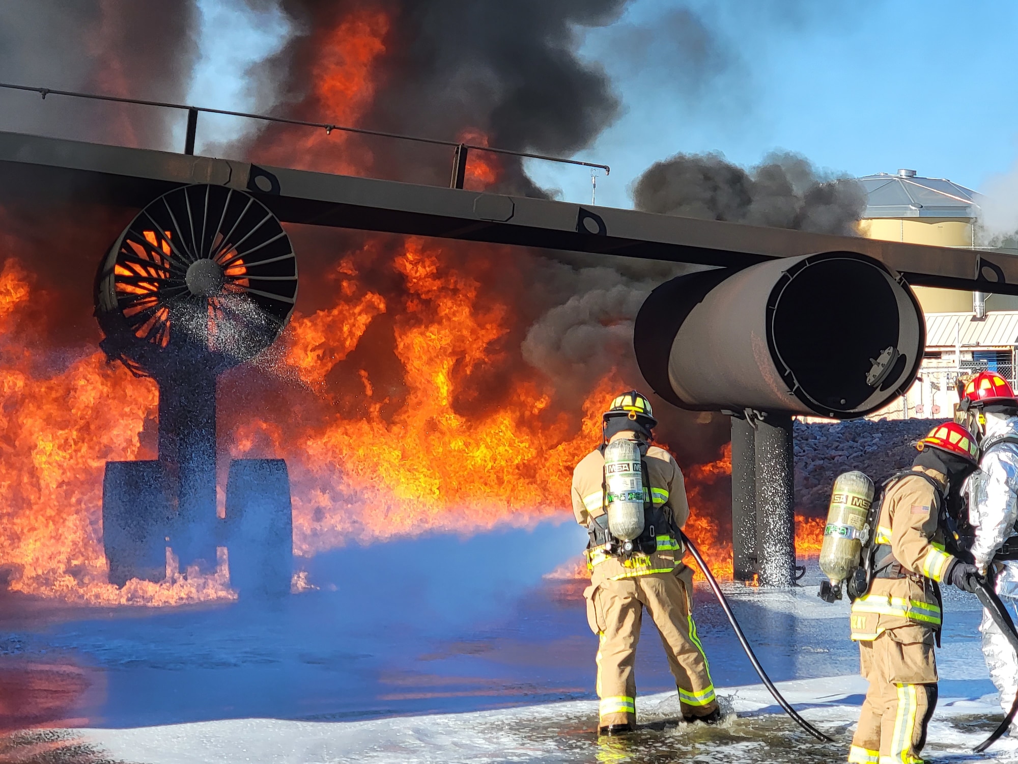 New York Air National Guard 106th Rescue Wing firefighters extinguish live-fire training props at Silver Flag exercise at Tyndall Air Force Base, Panama City, Fla., January 6, 2022. Nineteen Airmen from the 106th Civil Engineering Squadron traveled to Tyndall AFB for a 10-day exercise, where they trained and tested their readiness in preparation for deployment. (Courtesy Photo)