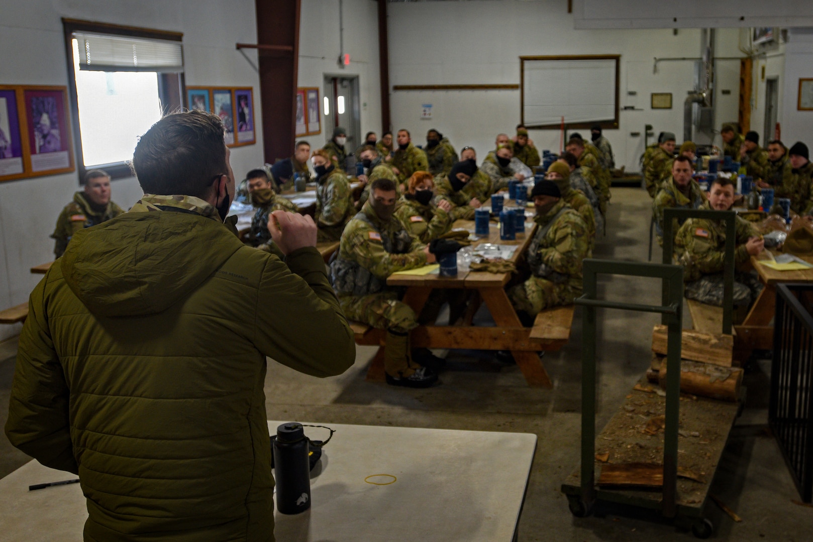 Staff Sgt. John Hampson, an instructor at the U.S. Army Mountain Warfare School, briefs students at the school’s Basic Military Mountaineer Course about their land navigation course requirements Jan. 19, 2022.