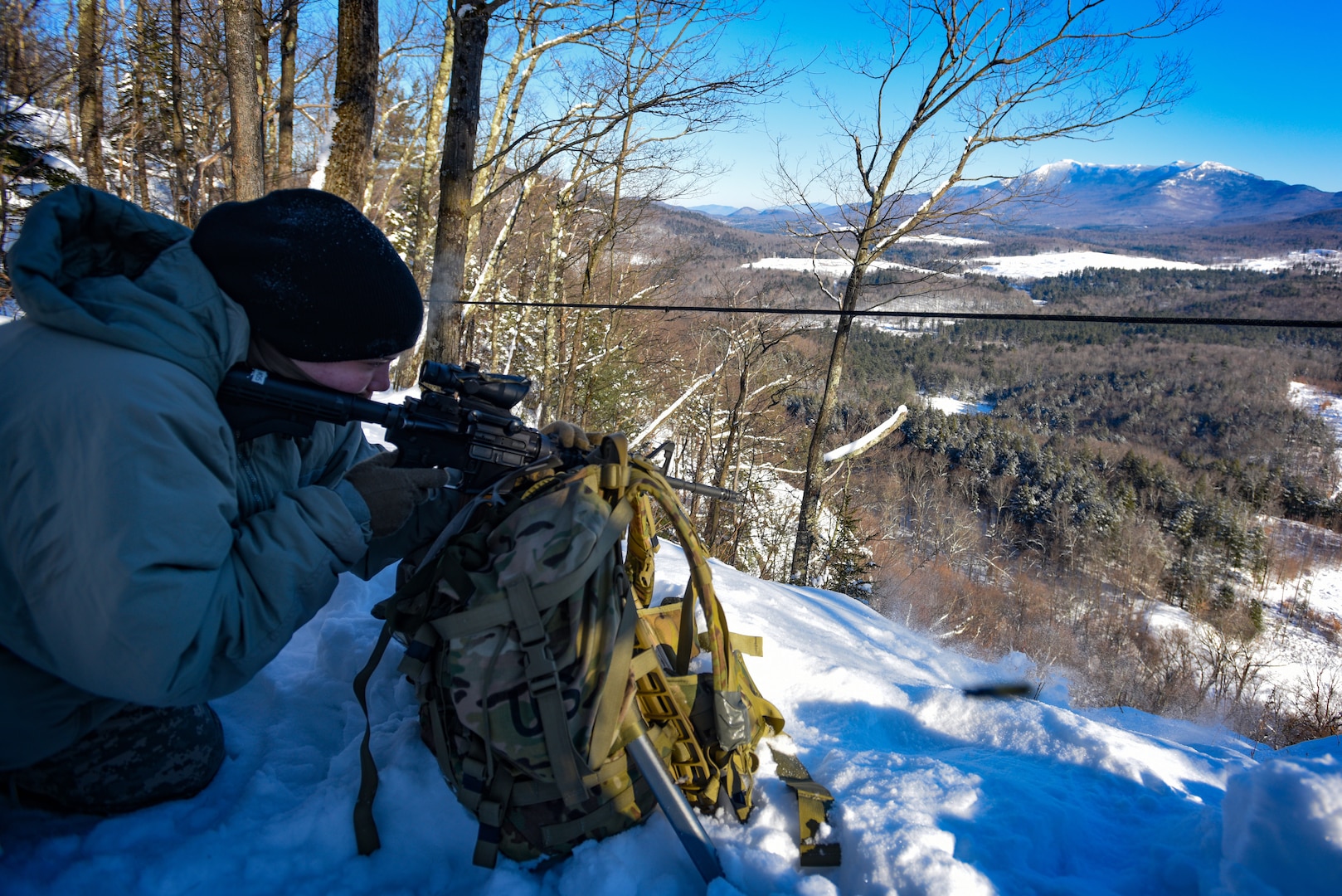 Cadet Elizabeth Carney, a student at the U.S. Army Mountain Warfare School’s Basic Military Mountaineer Course, shoots at a high-angle range Jan. 24, 2022. The school teaches basic, advanced and specialty mountain warfare courses to U.S. and foreign service members.