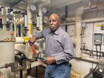 Felix Mulder, plumber and welder in the facilities and management department at  Walter Reed National Military Medical Center (WRNMMC), poses for a photo at  WRNMMC in Bethesda, Maryland.
