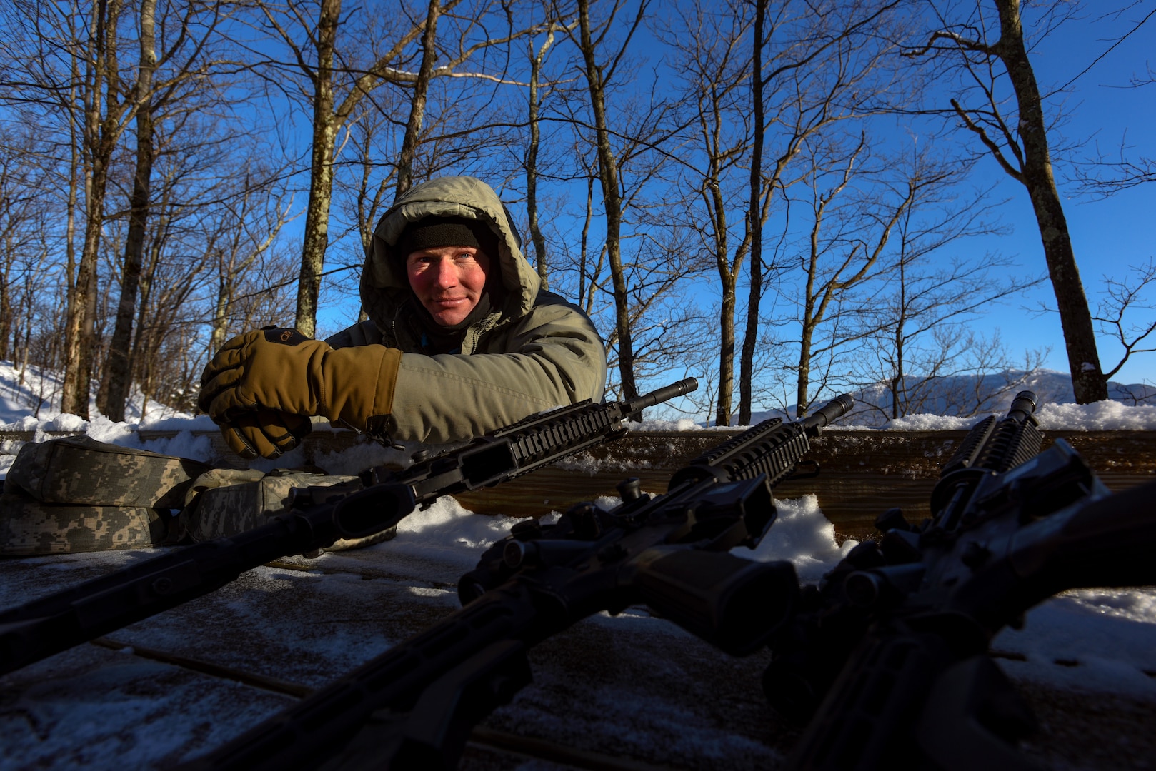Staff Sgt. Tim McLaughlin, an instructor at the U.S. Army Mountain Warfare School, at a high-angle shooting range during the school’s Basic Military Mountaineer Course Jan. 23, 2022. The AMWS is a U.S. Army Training and Doctrine Command school operated by the Vermont Army National Guard at Camp Ethan Allen Training Site, Vermont.