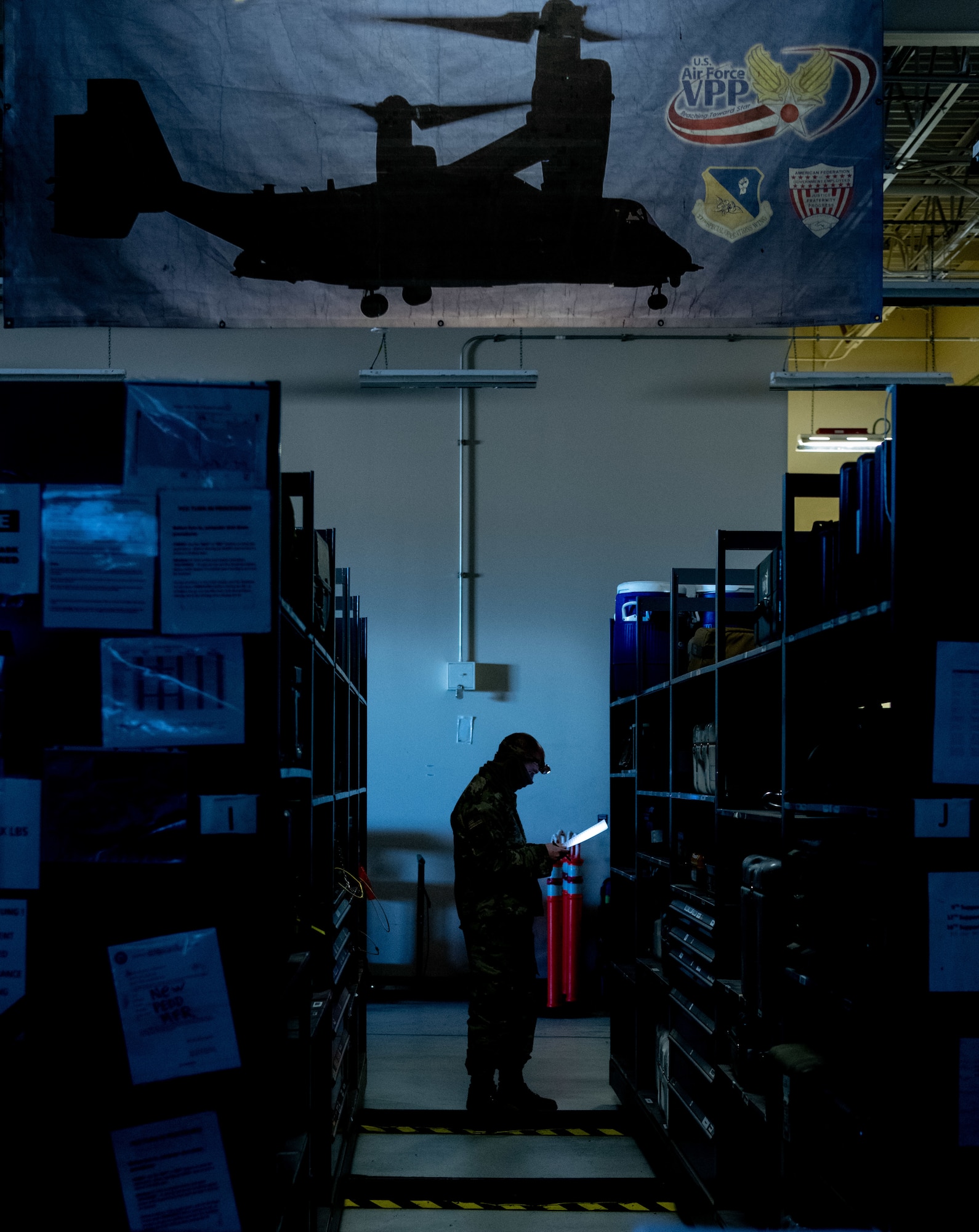 A U.S. Airman checks inventory during a simulated power outage.