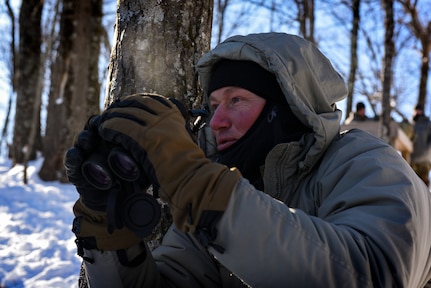 Staff Sgt. Tim McLaughlin, an instructor at the U.S. Army Mountain Warfare School, observes students shooting at a high-angle range during the school’s Basic Military Mountaineer Course at Camp Ethan Allen Training Site, Vermont, Jan. 23, 2022. The school teaches basic, advanced and specialty mountain warfare courses to U.S. and foreign service members.