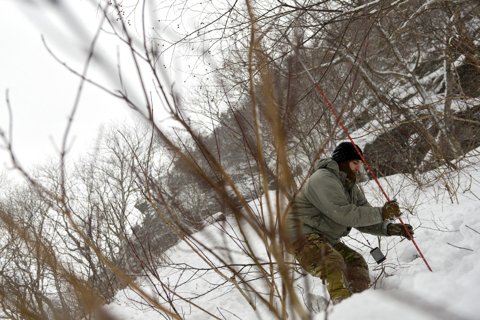 A student at the U.S. Army Mountain Warfare School’s Advanced Military Mountaineer Course uses a probe to find a simulated casualty during avalanche rescue training Jan. 25, 2022.