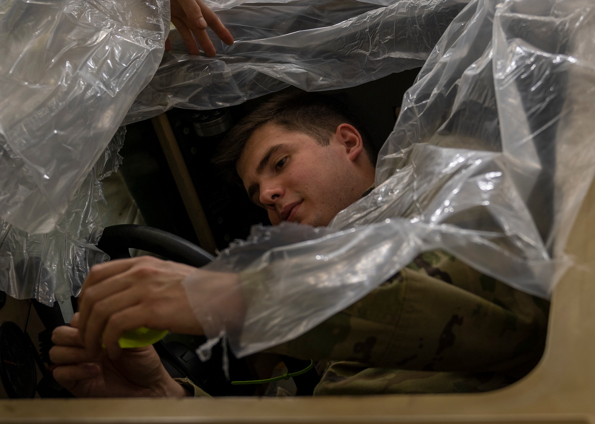 Airman 1st Class Ryan Hill, 4th Equipment Maintenance Squadron aircraft structural maintenance technician, masks off a mine-resistant, ambush-protected (MRAP) vehicle, prior to painting it at Seymour Johnson Air Force Base, North Carolina, Jan. 27, 2022.
