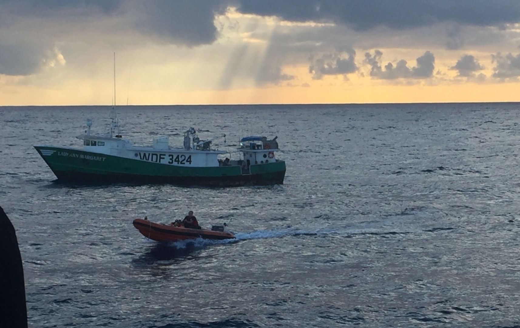 A boarding team from the Coast Guard Cutter Galveston Island, homeported in Honolulu, returns aboard a small boat from the 71-foot commercial fishing vessel Lady Ann Margaret for a fisheries boarding more than 350 miles off Oahu in support of the Coast Guard's Ocean Guardian Strategy March, 4, 2016. While on patrol with a NOAA National Marine Fisheries agent aboard, the crew conducted nine joint boardings resulting in two documented cases of illegal fishing. (U.S. Coast Guard photo by Seaman Calsea Clemens/Released)