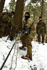 Staff Sgt. Christopher George, an instructor at the U.S. Army Mountain Warfare School, demonstrates a casualty evacuation technique to students at the school’s Basic Military Mountaineer Course Jan. 19, 2022. The AMWS is a U.S. Army Training and Doctrine Command school operated by the Vermont Army National Guard at Camp Ethan Allen Training Site, Vermont. The school teaches basic, advanced and specialty mountain warfare courses to U.S. and foreign service members.